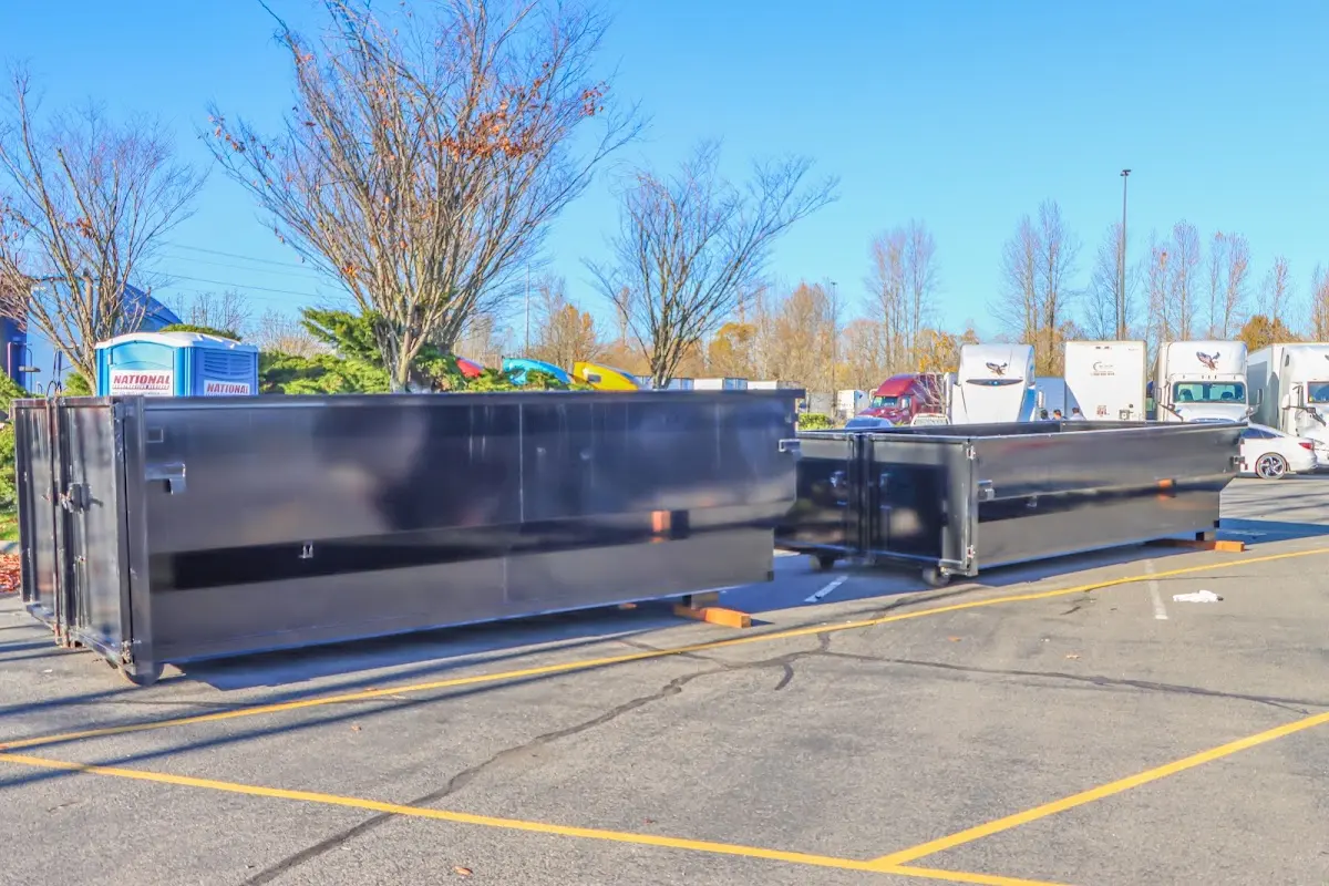 Professional dumpster rental service with roll-off container on residential driveway in Billings